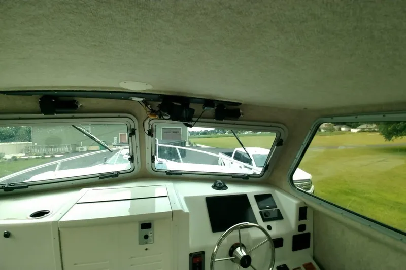  Yacht Photos Pics Interior view of 2024 Parker 2820 XLD Sport Cabin boat cockpit with steering wheel.
