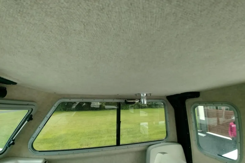  Yacht Photos Pics Interior view of 2024 Parker 2820 XLD Sport Cabin, featuring windows and seating.