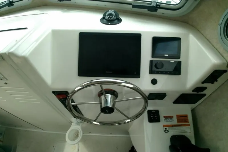  Yacht Photos Pics 2024 Parker 2820 XLD Sport Cabin helm with steering wheel and navigation controls.