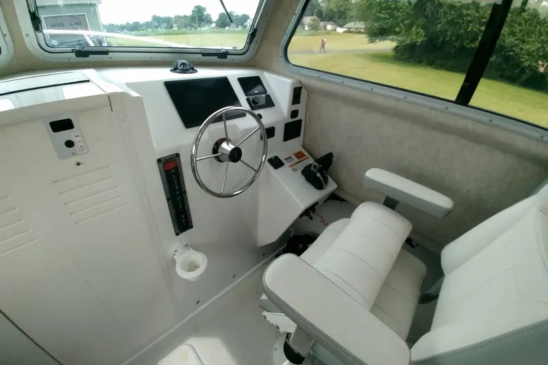  Yacht Photos Pics 2024 Parker 2820 XLD Sport Cabin interior with steering wheel and control panel.