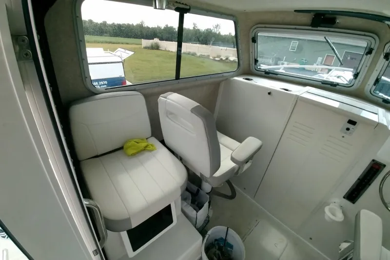 Yacht Photos Pics 2024 Parker 2820 XLD Sport Cabin interior with seating and windows.