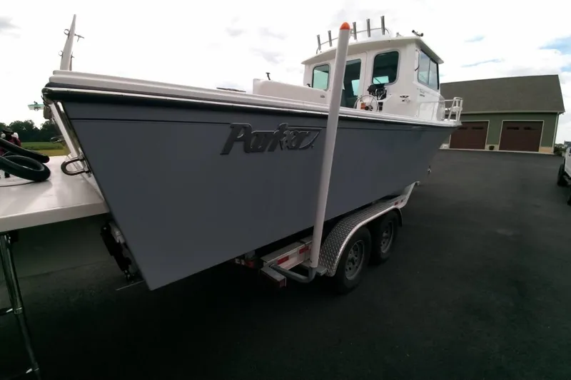  Yacht Photos Pics 2024 Parker 2820 XLD Sport Cabin boat on trailer, parked outdoors.