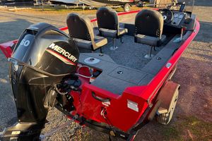 2026 Tracker Pro Guide V-16 SC boat with Mercury engine, red exterior, and seating for four.