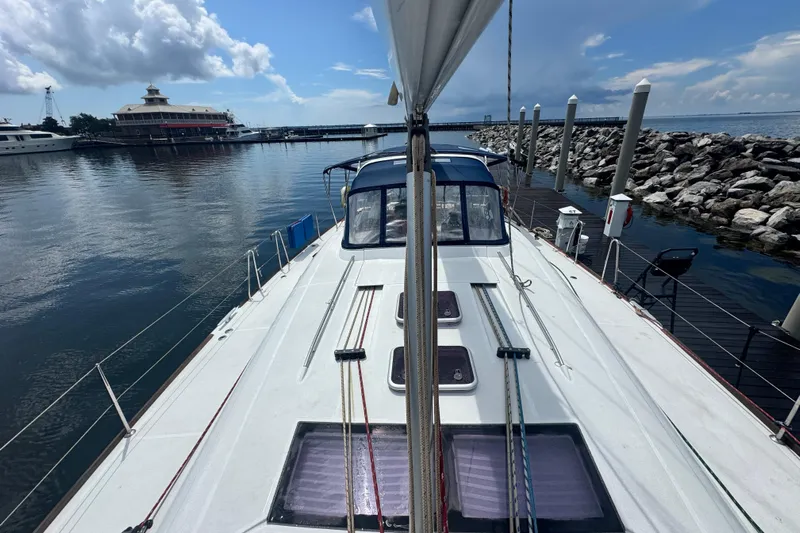  Yacht Photos Pics 2011 Beneteau Oceanis 50 sailboat docked at marina, calm waters, partly cloudy sky.