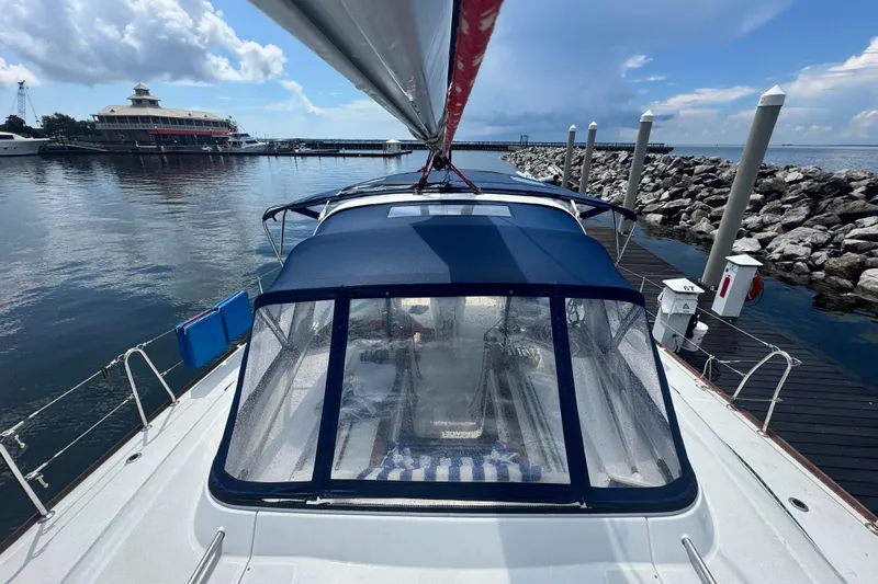  Yacht Photos Pics 2011 Beneteau Oceanis 50 sailboat docked at marina, blue canopy, clear skies.