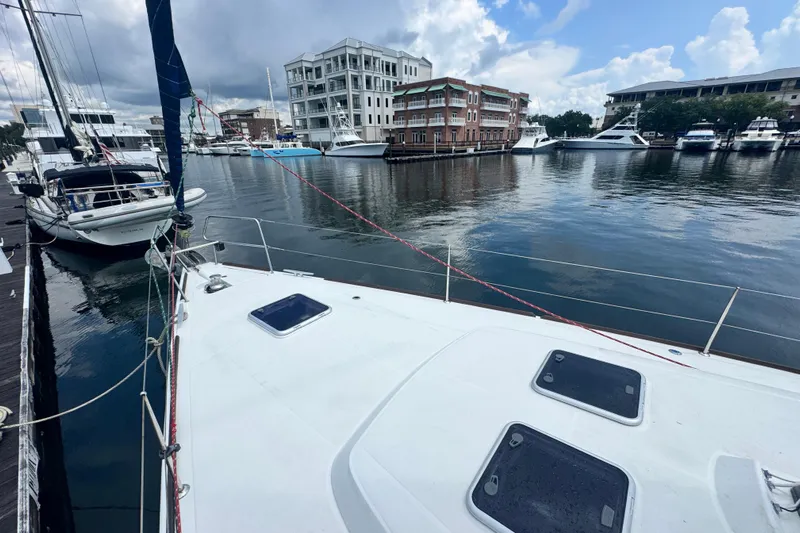 Yacht Photos Pics Beneteau Oceanis 50 sailboat docked in a marina, surrounded by other boats, 2011 model.