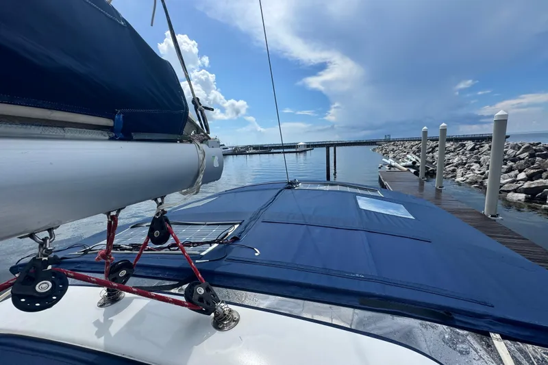  Yacht Photos Pics Beneteau Oceanis 50 sailboat docked, showcasing deck and rigging under a clear sky.