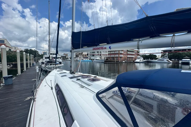  Yacht Photos Pics 2011 Beneteau Oceanis 50 sailboat docked at marina, under cloudy sky.