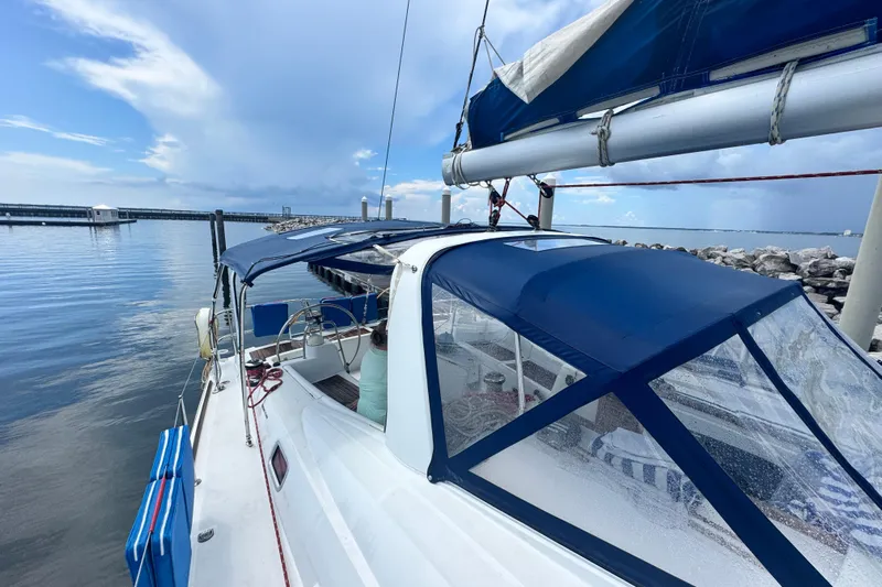  Yacht Photos Pics 2011 Beneteau Oceanis 50 sailboat docked, featuring blue canopy and calm waters.