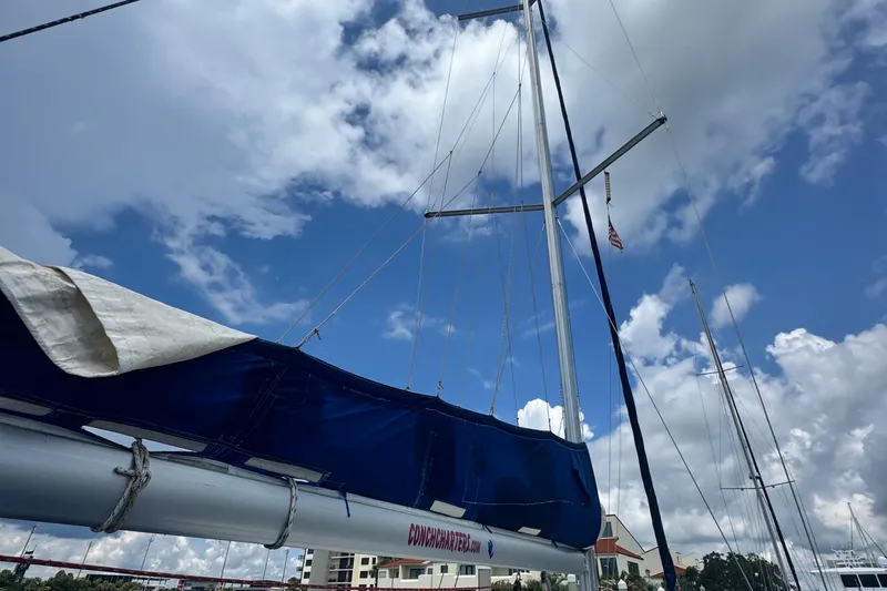  Yacht Photos Pics 2011 Beneteau Oceanis 50 sailboat mast against a cloudy blue sky.