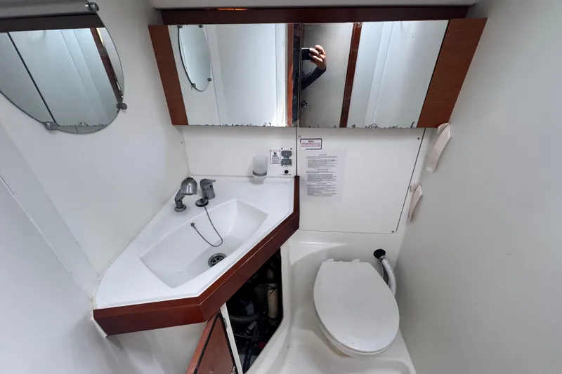  Yacht Photos Pics Bathroom of 2011 Beneteau Oceanis 50 yacht with sink, mirror, and toilet.