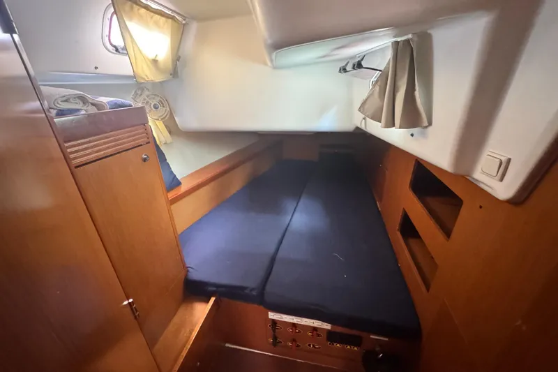  Yacht Photos Pics Cozy cabin interior of 2011 Beneteau Oceanis 50 sailboat with wooden furnishings.