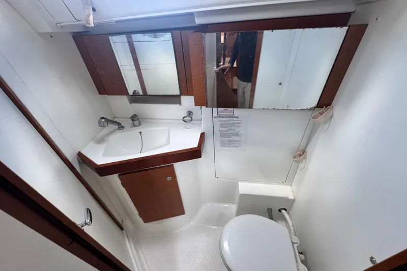  Yacht Photos Pics Bathroom interior of 2011 Beneteau Oceanis 50 yacht, featuring sink, mirror, and toilet.