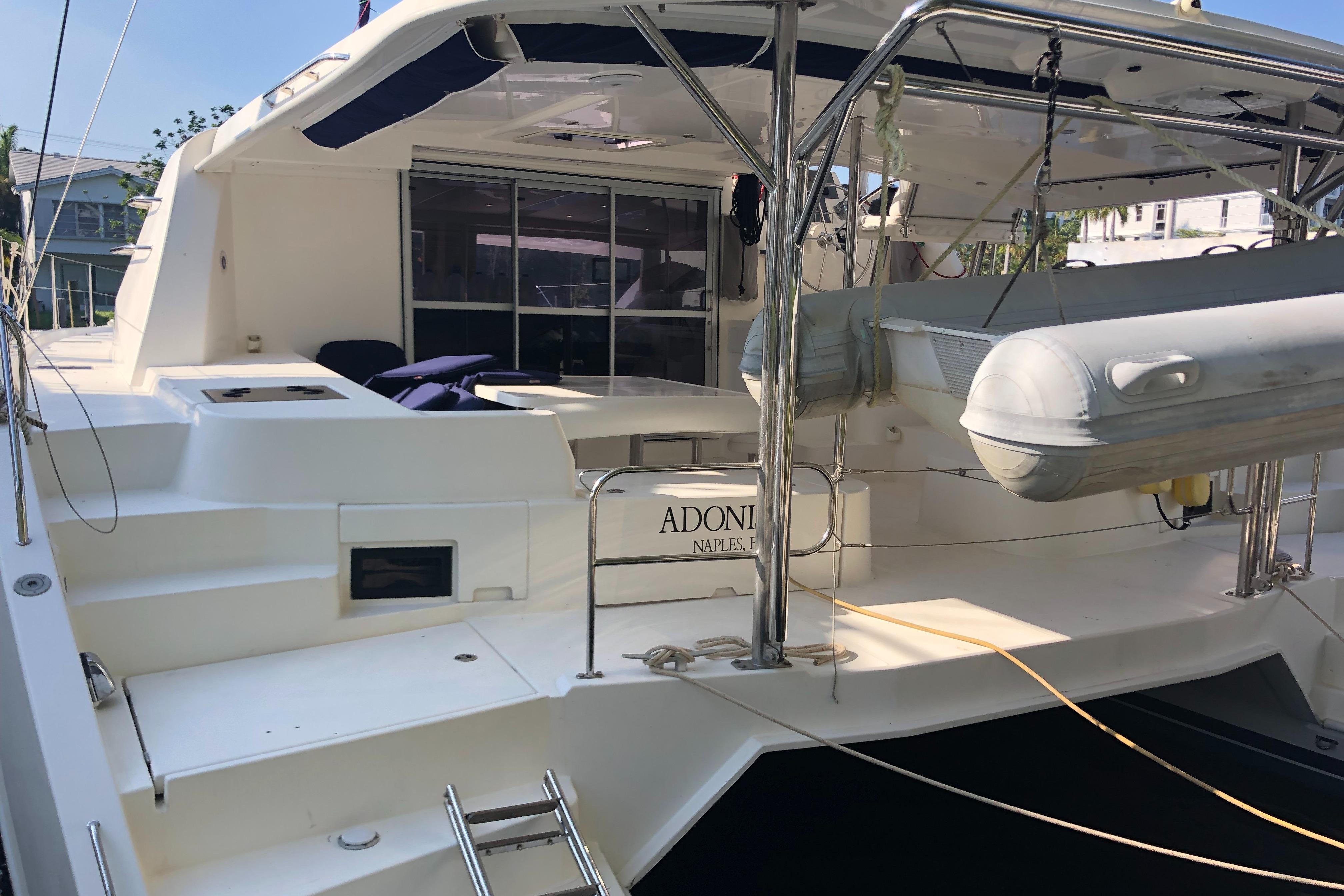 2017 Leopard 48 yacht with spacious deck and dinghy, docked at marina.