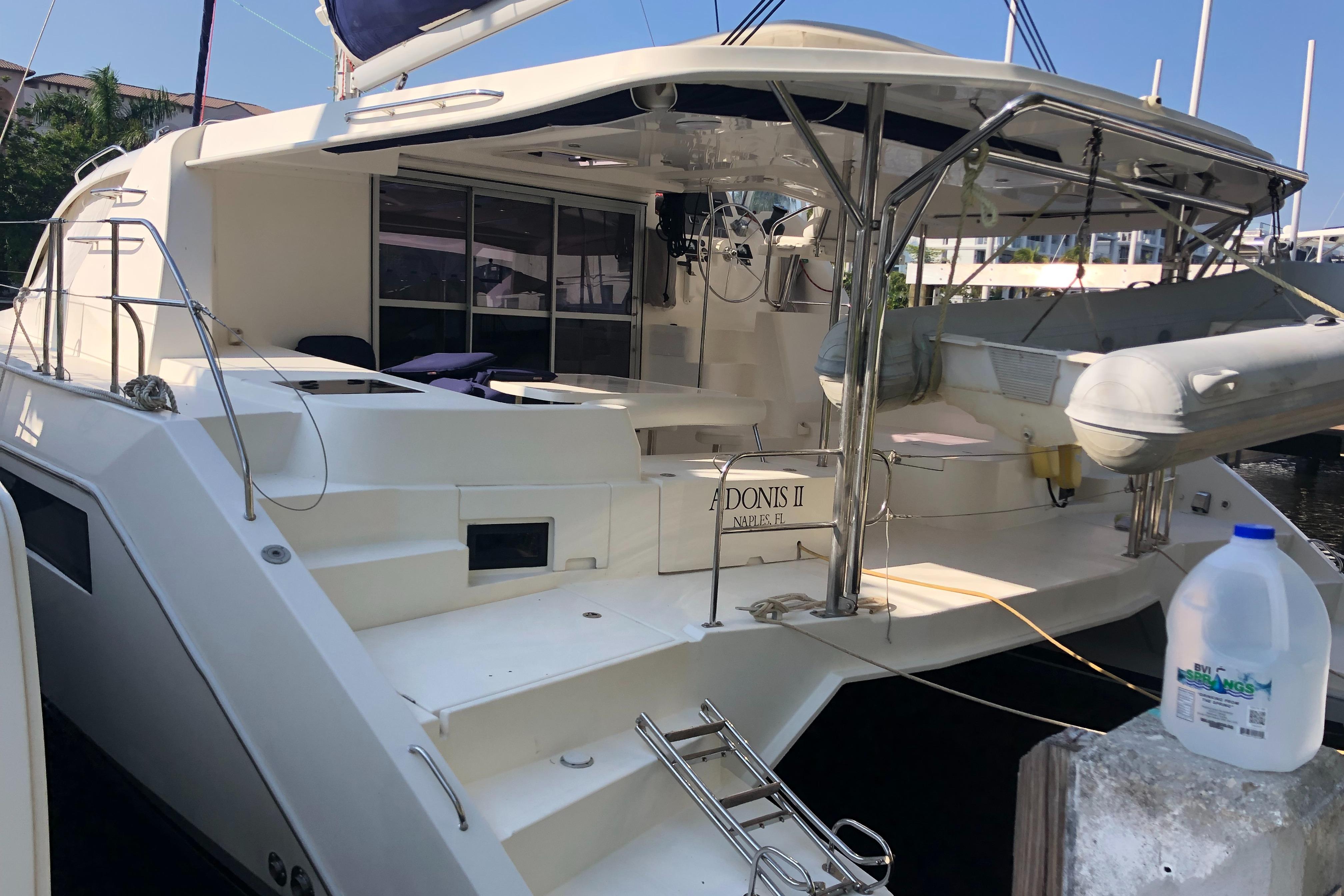 Luxury Leopard 48 yacht, 2017 model, docked with spacious deck and dinghy.