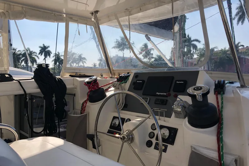 Adonis II Yacht Photos Pics Interior view of 2017 Leopard 48 yacht cockpit with steering wheel and navigation equipment.