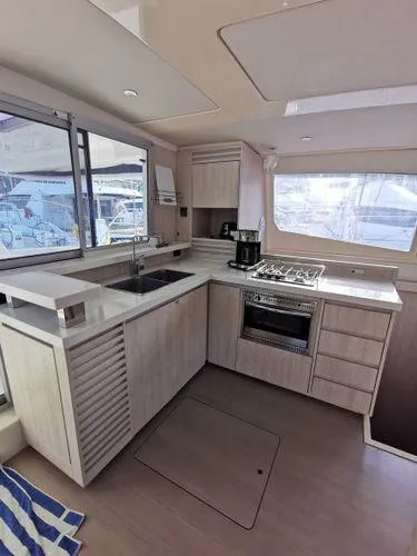 Adonis II Yacht Photos Pics Modern kitchen interior of 2017 Leopard 48 yacht with stove, sink, and ample counter space.
