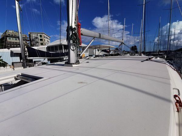 2017 Leopard 48 yacht deck in marina, clear sky, and surrounding boats.