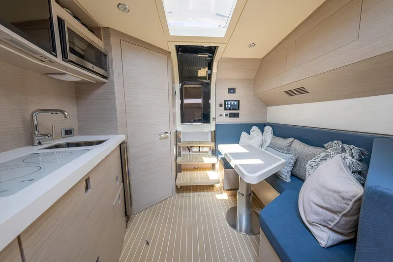 Dealership II Yacht Photos Pics Luxurious interior of 2023 Scout 530 LXF yacht with modern kitchen and seating area.