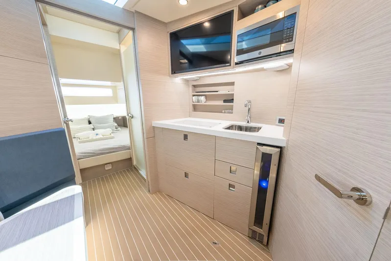 Dealership II Yacht Photos Pics Luxurious interior of 2023 Scout 530 LXF yacht featuring modern kitchenette and cozy bedroom.