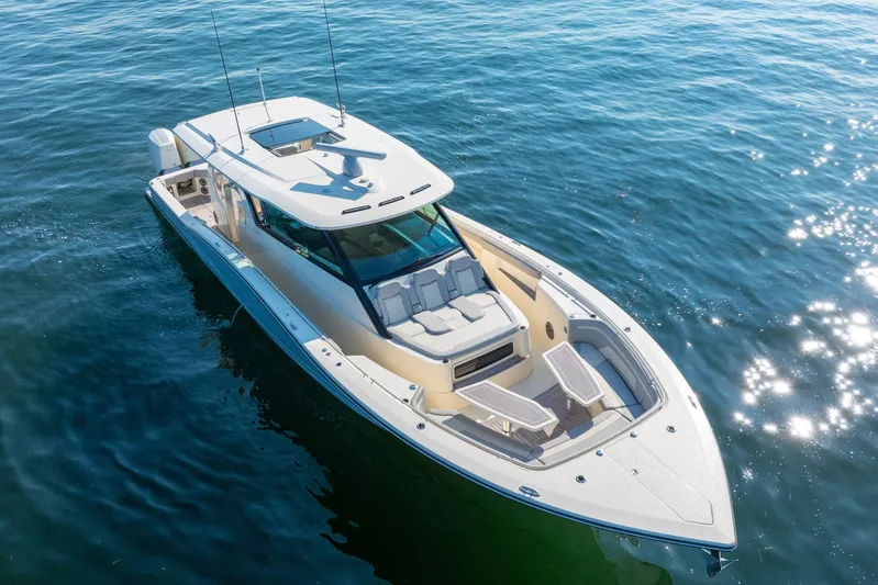 Dealership II Yacht Photos Pics 2023 Scout 530 LXF luxury boat cruising on open water, aerial view.