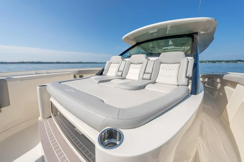 Dealership II Yacht Photos Pics 2023 Scout 530 LXF luxury boat with plush seating on a sunny day.