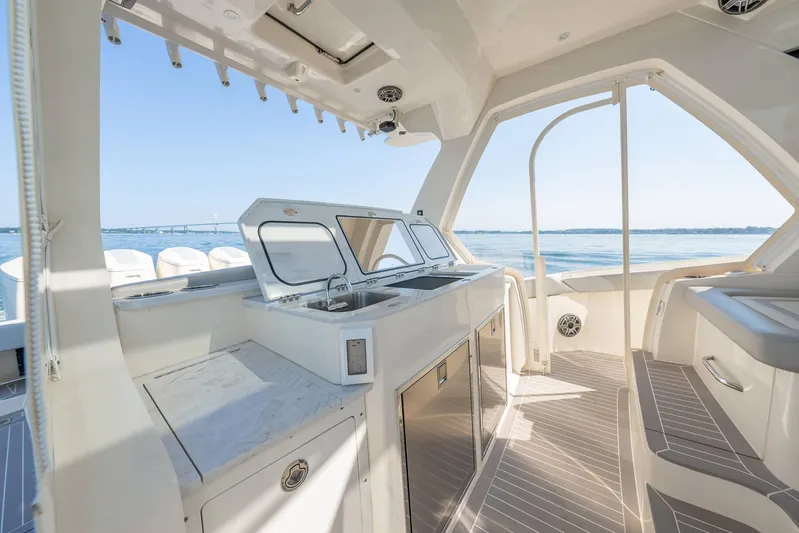 Dealership II Yacht Photos Pics Luxurious 2023 Scout 530 LXF yacht interior with sleek kitchen and ocean view.