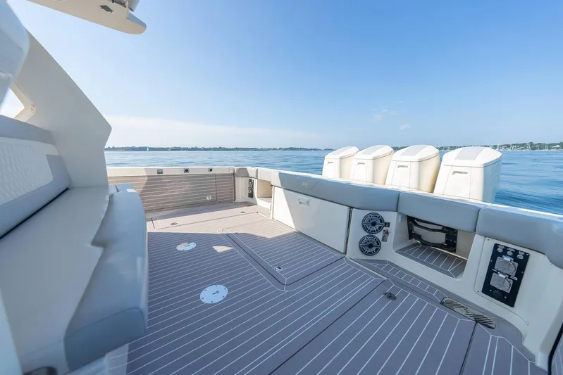 Dealership II Yacht Photos Pics 2023 Scout 530 LXF boat deck with seating, speakers, and ocean view.