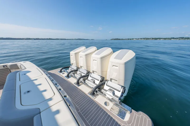 Dealership II Yacht Photos Pics 2023 Scout 530 LXF boat with four powerful outboard engines on calm water.