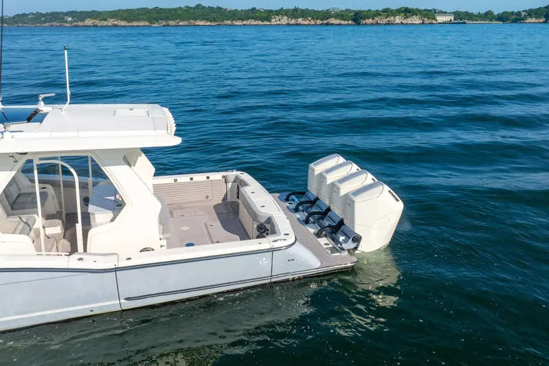 Dealership II Yacht Photos Pics 2023 Scout 530 LXF boat with triple engines on open water.