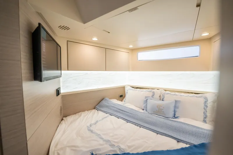 Dealership II Yacht Photos Pics Luxurious cabin interior of 2023 Scout 530 LXF yacht with cozy bedding and TV.