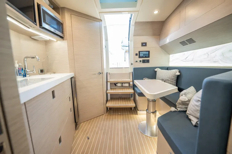 Dealership II Yacht Photos Pics Luxurious interior of 2023 Scout 530 LXF yacht with modern kitchen and seating area.