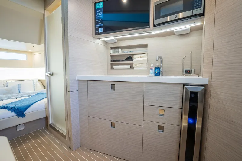 Dealership II Yacht Photos Pics 2023 Scout 530 LXF yacht interior with modern kitchenette and cozy bedroom.