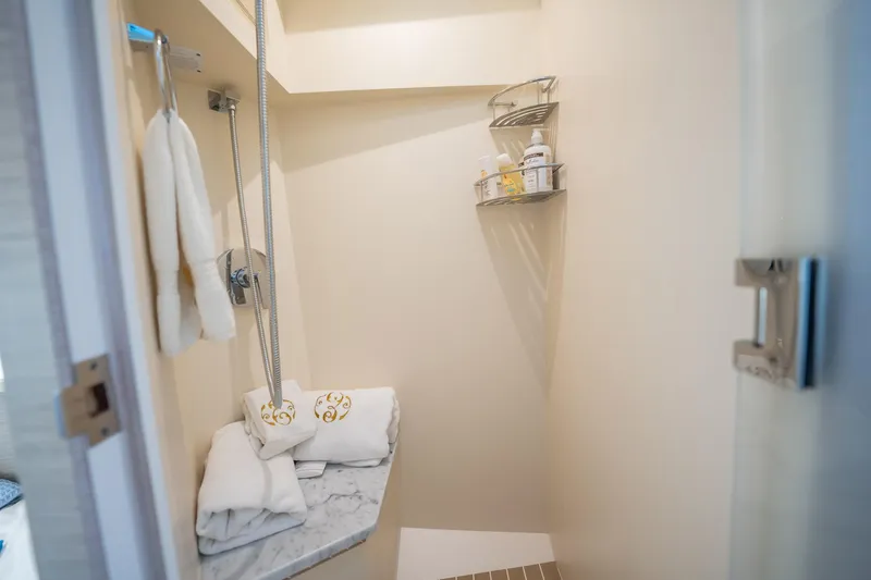 Dealership II Yacht Photos Pics Luxurious shower area in 2023 Scout 530 LXF yacht with towels and toiletries.