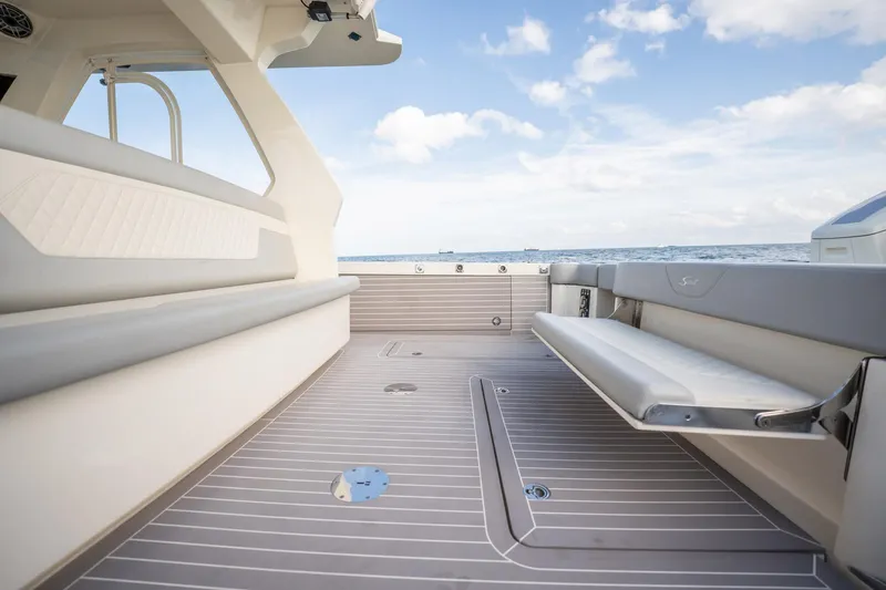 Dealership II Yacht Photos Pics 2023 Scout 530 LXF boat deck with seating, ocean view, and clear sky.