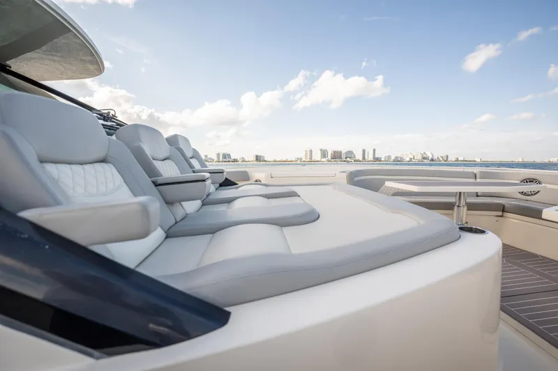 Dealership II Yacht Photos Pics Luxurious seating on 2023 Scout 530 LXF yacht with city skyline in background.