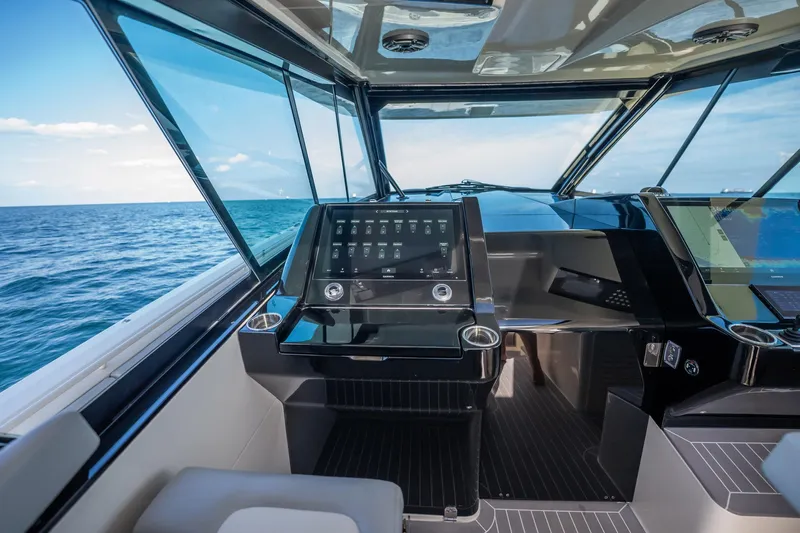 Dealership II Yacht Photos Pics 2023 Scout 530 LXF boat cockpit with modern navigation system and ocean view.
