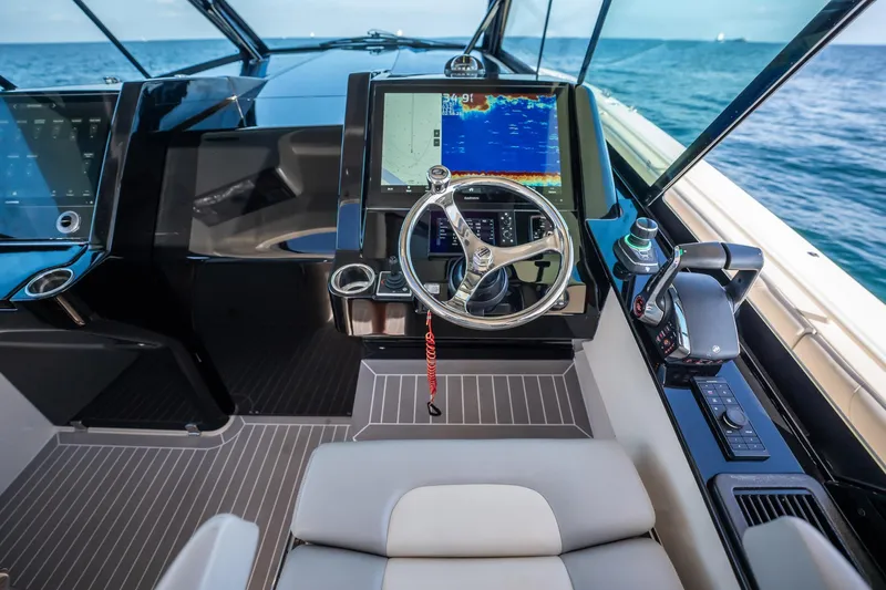 Dealership II Yacht Photos Pics 2023 Scout 530 LXF helm with advanced navigation system and luxurious seating.