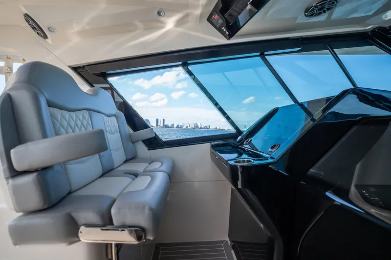Dealership II Yacht Photos Pics Interior view of 2023 Scout 530 LXF yacht with luxurious seating and ocean backdrop.