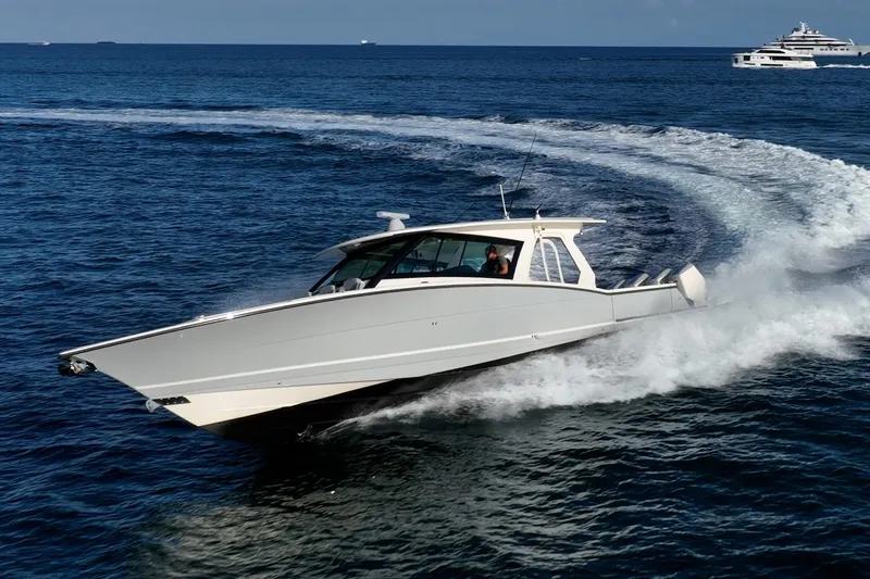 Dealership II Yacht Photos Pics 2023 Scout 530 LXF luxury boat cruising on open ocean waters.