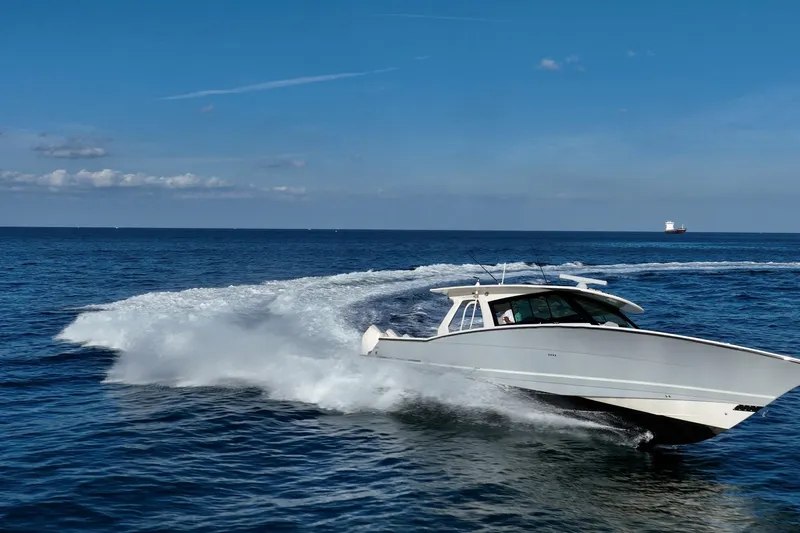 Dealership II Yacht Photos Pics 2023 Scout 530 LXF boat cruising on open sea under clear blue sky.