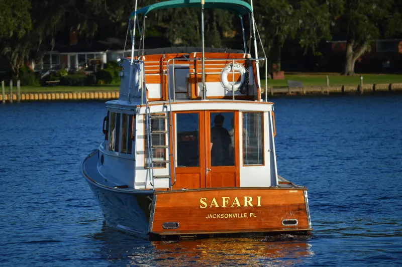 Safari Yacht Photos Pics 1990 Stanley Downeast Lobster Boat cruising on water, named "Safari" from Jacksonville, FL.