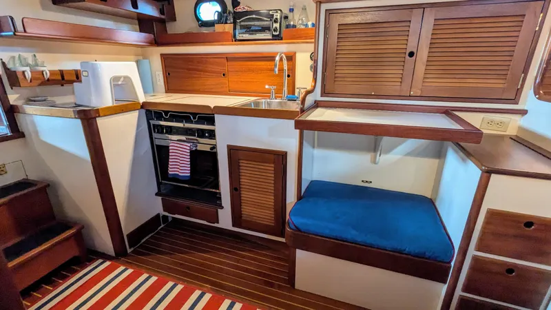 Safari Yacht Photos Pics Interior of a 1990 Stanley Downeast Lobster Yacht with kitchen and seating area.