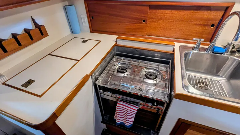 Safari Yacht Photos Pics Compact kitchen area in a 1990 Stanley Downeast Lobster Yacht with stove and sink.