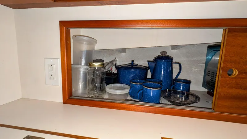Safari Yacht Photos Pics Kitchen shelf with blue enamel cookware and jars on a 1990 Stanley Downeast Lobster Boat.