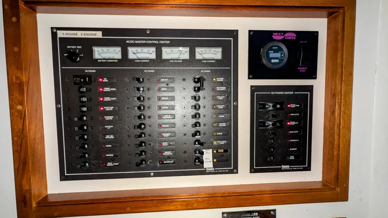 Safari Yacht Photos Pics Electrical control panel on a 1990 Stanley Downeast Lobster Boat, featuring switches and gauges.