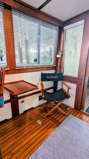 Safari Yacht Photos Pics Interior of 1990 Stanley Downeast Lobster Yacht with wooden flooring and director's chair.