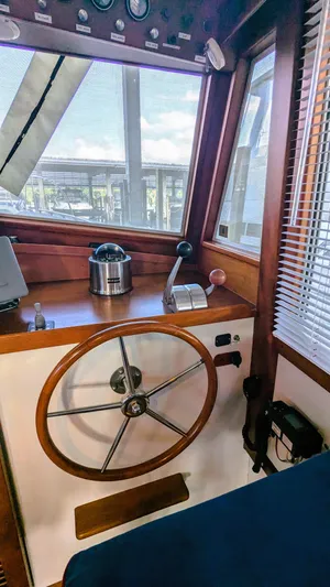 Safari Yacht Photos Pics Interior of 1990 Stanley Downeast Lobster Boat with wooden steering wheel and controls.