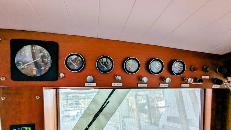 Safari Yacht Photos Pics Control panel of a 1990 Stanley Downeast Lobster Boat with gauges and switches.