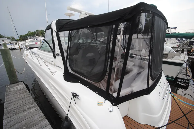  Yacht Photos Pics 2002 Sea Ray 380 Sundancer docked, featuring a black canvas enclosure and sleek white exterior.